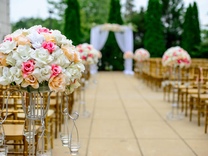 Flowers in focus overlooking an aisle of chairs