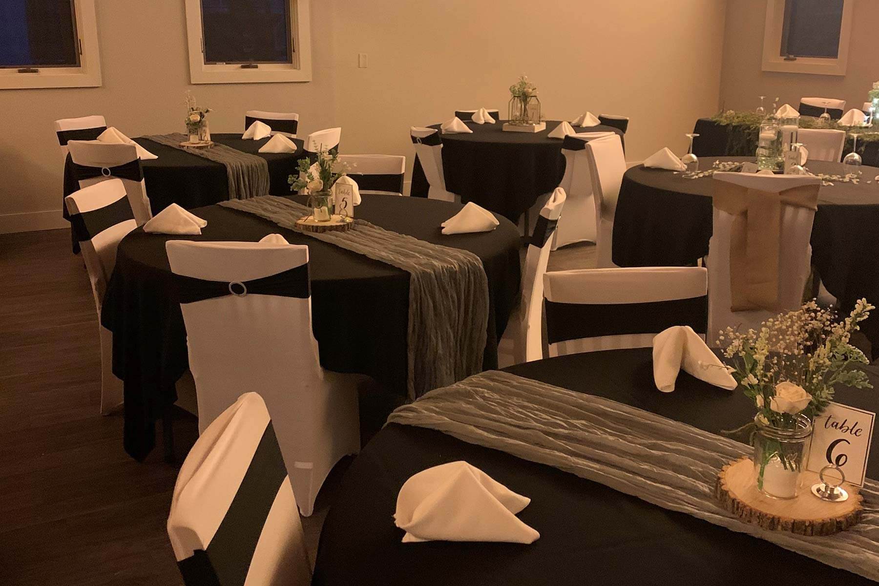 A group of tables decorated for a formal occasion